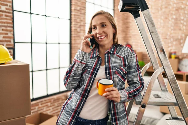 Young Blonde Woman Talking Smartphone Drinking Coffee New Home — Fotografia de Stock