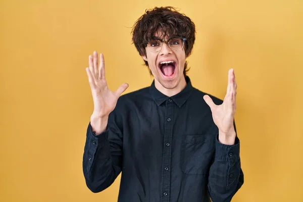Young Man Wearing Glasses Yellow Background Celebrating Crazy Amazed Success — Stock Photo, Image