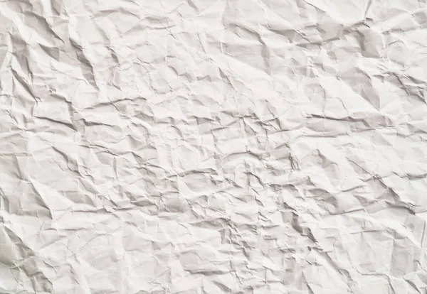 White crumpled paper texture with wrinkles. Damaged and torn sheet