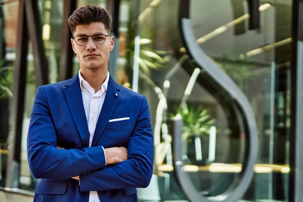 Young man relaxed wearing suit and glasses at street