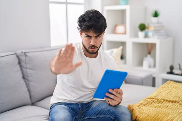 Hispanic Man Beard Using Touchpad Sitting Sofa Doing Stop Gesture — Stock Photo, Image