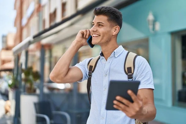 Young Hispanic Man Student Talking Smartphone Using Touchpad Street —  Fotos de Stock