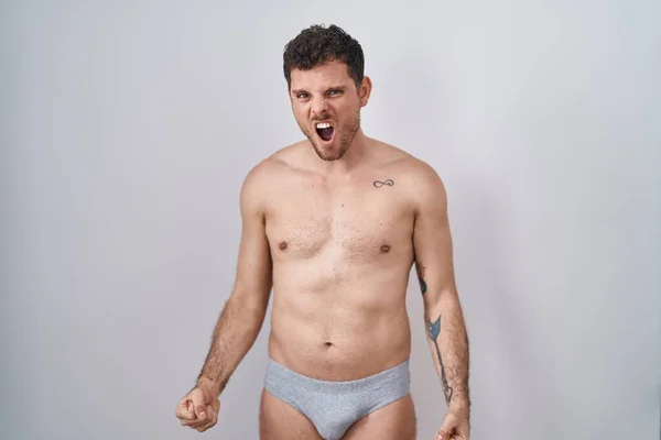 Young Hispanic Man Standing Shirtless Wearing Underware Angry Mad Screaming — Stock Photo, Image