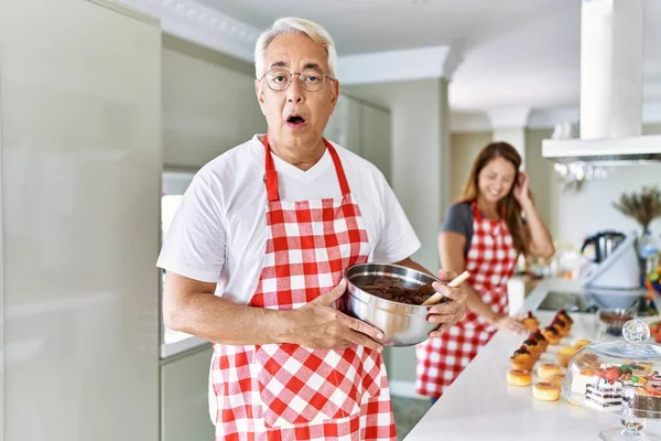 Middle Age Hispanic Couple Wearing Apron Cooking Homemade Pastry Scared — Stock Photo, Image