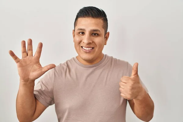 Hispanic Young Man Standing White Background Showing Pointing Fingers Number — Stock Photo, Image