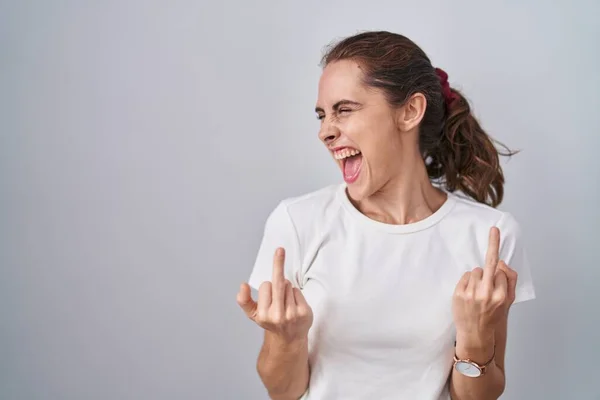 Beautiful Brunette Woman Standing Isolated Background Showing Middle Finger Doing — стоковое фото