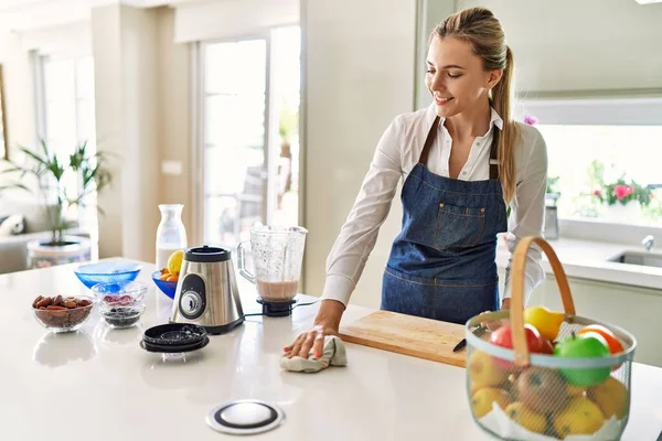 Genç Sarışın Kadın Mutfaktaki Kendine Güvenen Temizlik Masasında Gülümsüyor — Stok fotoğraf