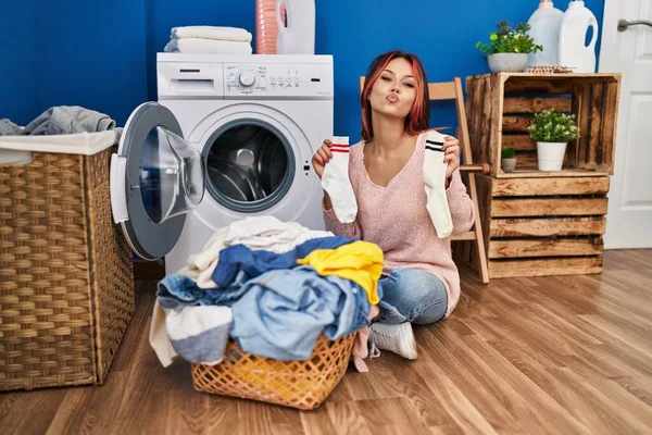 Young Caucasian Woman Doing Laundry Holding Socks Looking Camera Blowing — Stock Photo, Image