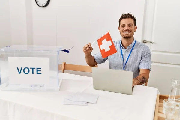 Young Hispanic Man Smiling Confident Holding Switzerland Flag Working Electoral — Zdjęcie stockowe