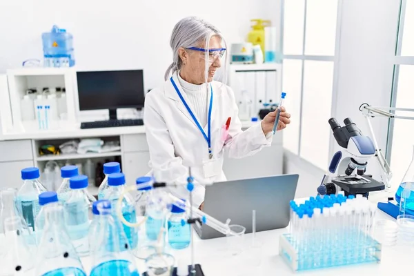 Middle Age Grey Haired Woman Wearing Scientist Uniform Using Laptop — Stock Photo, Image