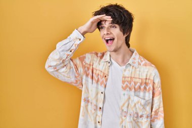 Yazlık tişört giyen genç adam çok mutlu ve gülümsüyor. Çok uzaklara bakıyor. arama kavramı. 