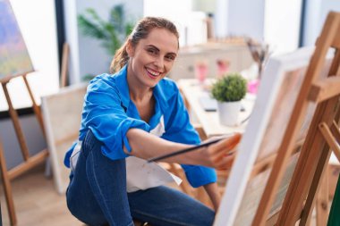 Young woman artist smiling confident drawing at art studio