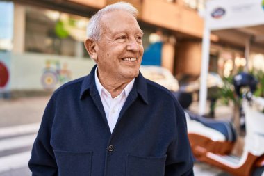 Son sınıf öğrencisi sokakta kendinden emin bir şekilde gülümsüyor.