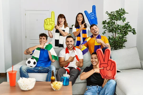 Group of people football hooligan cheering game smiling happy pointing with hand and finger