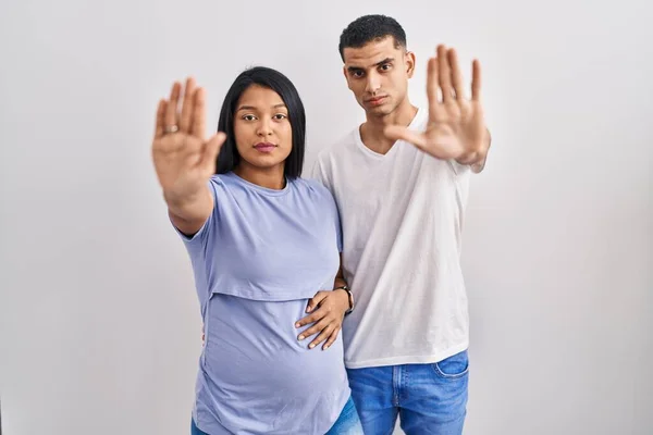 Young Hispanic Couple Expecting Baby Standing Background Doing Stop Sing — Stock Photo, Image