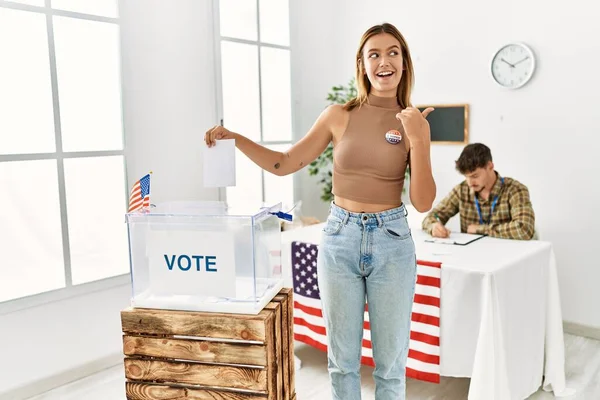 Young Blonde Girl Voting Putting Envelop Ballot Box Pointing Thumb — ストック写真