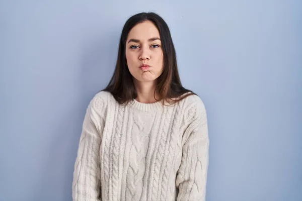 Young Brunette Woman Standing Blue Background Puffing Cheeks Funny Face — Stock Photo, Image