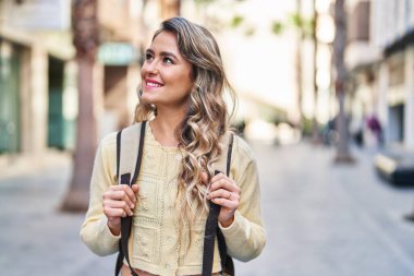 Young woman tourist smiling confident walking at street