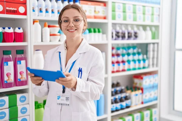 Young Blonde Woman Pharmacist Using Touchpad Working Pharmacy — Stok fotoğraf