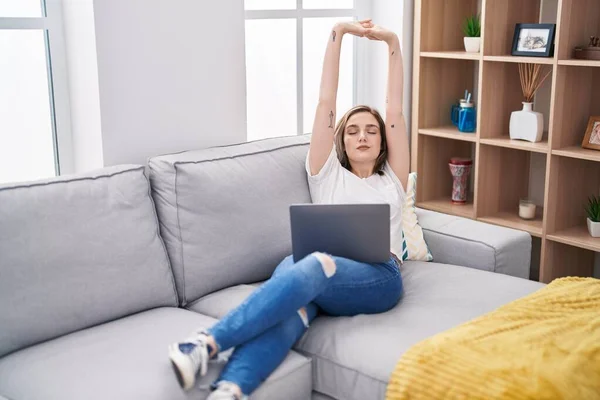 Young Woman Using Laptop Stretching Arms Home — Stockfoto