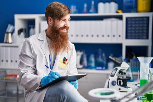 Young Redhead Man Scientist Writing Report Working Laboratory — стоковое фото