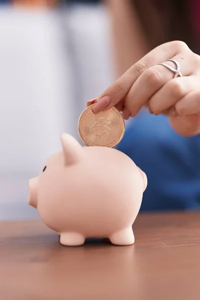 Young Caucasian Woman Inserting Uniswap Coin Piggy Bank Home — Stock Photo, Image