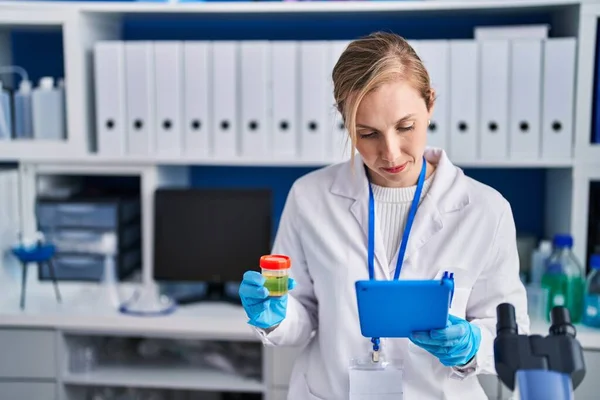 Young Blonde Woman Scientist Using Touchpad Holding Urine Test Tube — Stock Photo, Image