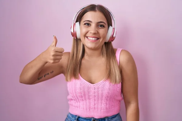 Young Blonde Woman Listening Music Using Headphones Doing Happy Thumbs — Foto de Stock