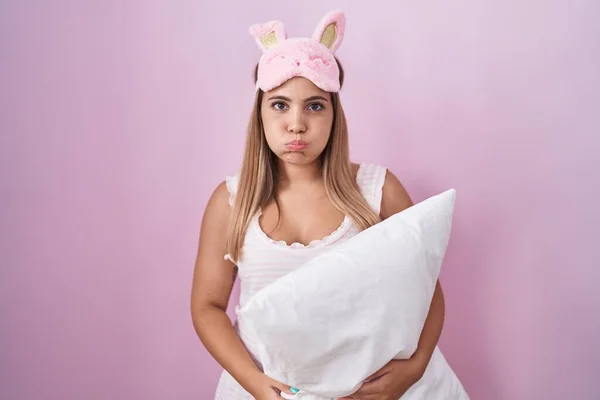 Young Blonde Woman Wearing Pyjama Hugging Pillow Puffing Cheeks Funny — Stockfoto