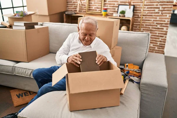 Senior Man Smiling Confident Unboxing Package New Home — Fotografia de Stock