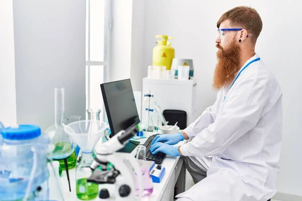 Young Redhead Man Wearing Scientist Uniform Working Laboratory — Stockfoto