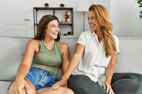 Madre Hija Sonriendo Confiadas Sentadas Sofá Casa —  Fotos de Stock