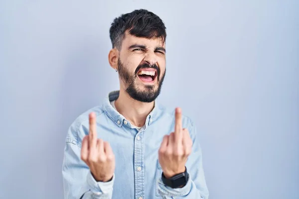 Young Hispanic Man Beard Standing Blue Background Showing Middle Finger — Stockfoto