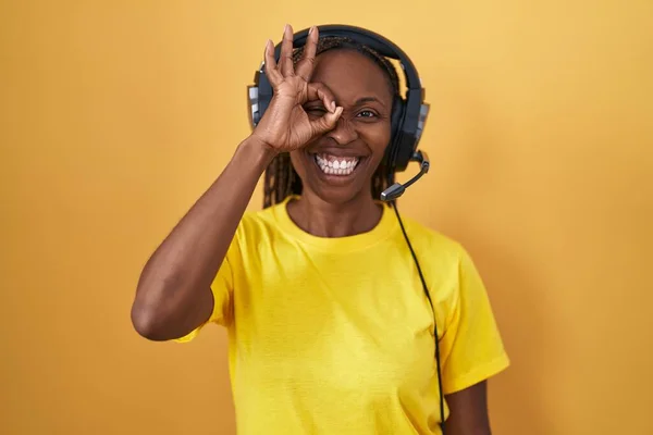 African American Woman Listening Music Using Headphones Doing Gesture Hand — Stock Photo, Image