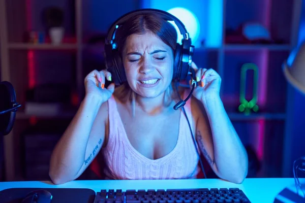 Young Blonde Woman Playing Video Games Wearing Headphones Covering Ears — Photo