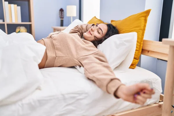 Young Hispanic Woman Stretching Arms Lying Bed Bedroom — Stok fotoğraf