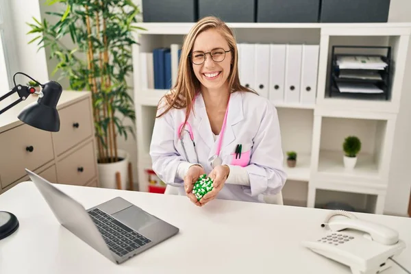 Sarışın kadın elinde haplarla gülüyor ve kahkahalarla gülüyor.. 