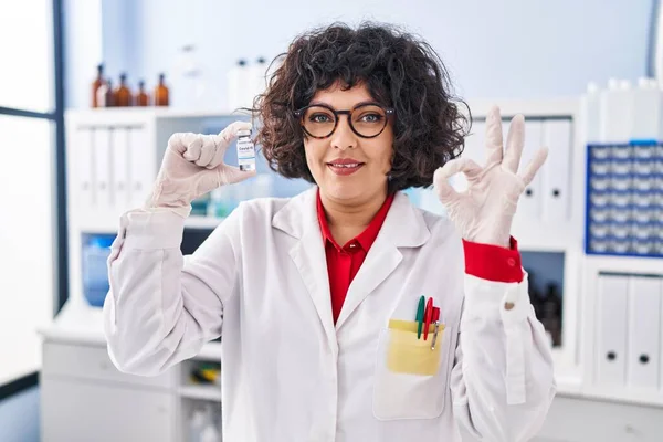 Hispanic Doctor Woman Curly Hair Holding Vaccine Doing Sign Fingers — Stock Photo, Image