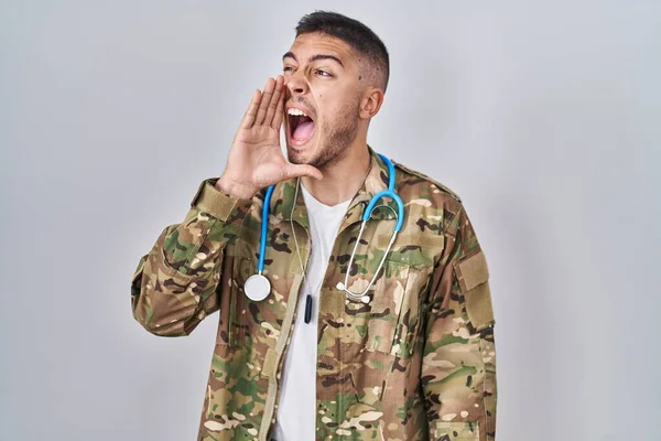 Young Hispanic Doctor Wearing Camouflage Army Uniform Clueless Confused Open — Stock Photo, Image