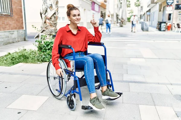 Young Brunette Woman Sitting Wheelchair Outdoors Surprised Idea Question Pointing — стоковое фото