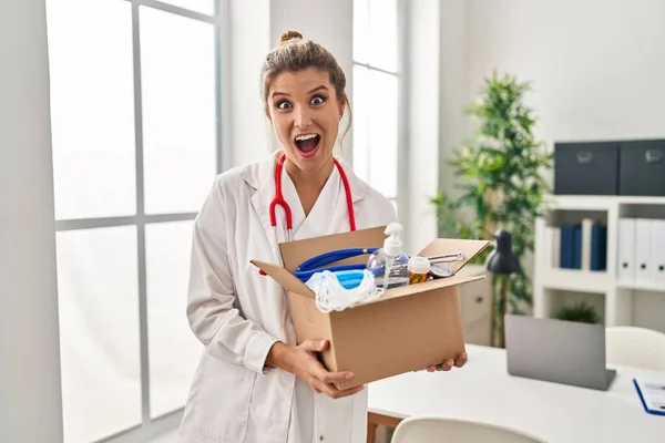 Young Doctor Woman Holding Box Medical Items Afraid Shocked Surprise — Stock Photo, Image