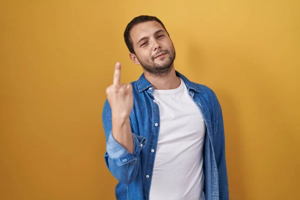 Hispanic Man Standing Yellow Background Showing Middle Finger Impolite Rude — стокове фото