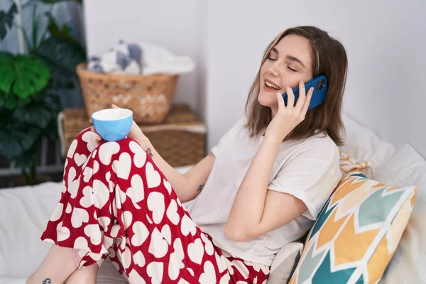 Young Woman Talking Smartphone Drinking Coffee Bedroom – stockfoto