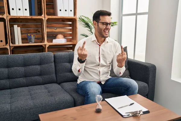 Young Hispanic Man Beard Working Consultation Office Showing Middle Finger — Stockfoto