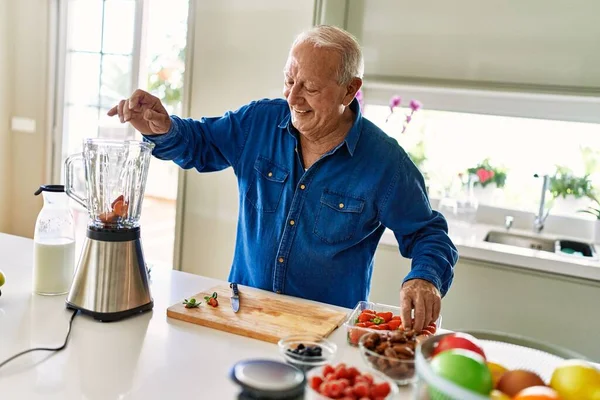 Senior Man Smiling Confident Putting Strawberry Blender Kitchen —  Fotos de Stock