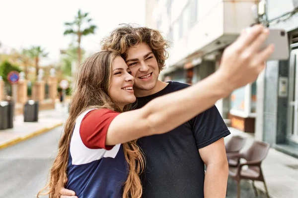 Young Caucasian Couple Smiling Happy Hugging Make Selfie Smartphone City — Stock Photo, Image