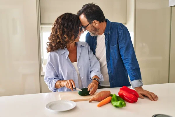 Middle Age Hispanic Couple Hugging Each Other Cooking Kitchen —  Fotos de Stock