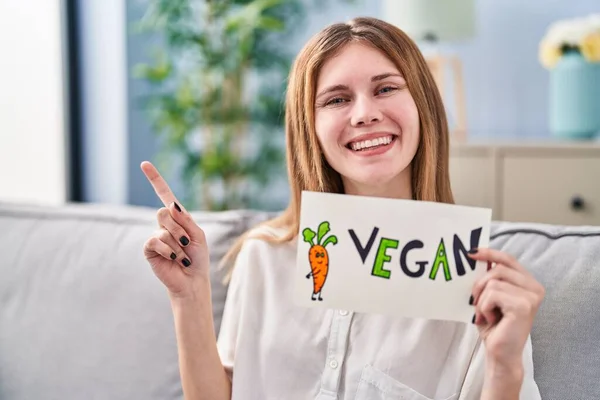 Beautiful Woman Holding Banner Vegan Word Smiling Happy Pointing Hand — Stock Photo, Image