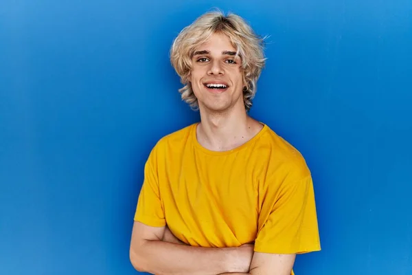 Joven Hombre Moderno Pie Sobre Fondo Azul Cara Feliz Sonriendo —  Fotos de Stock