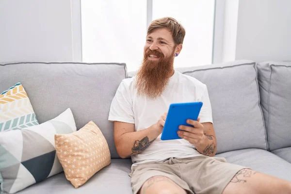 Young Redhead Man Using Touchpad Sitting Sofa Home — Foto Stock